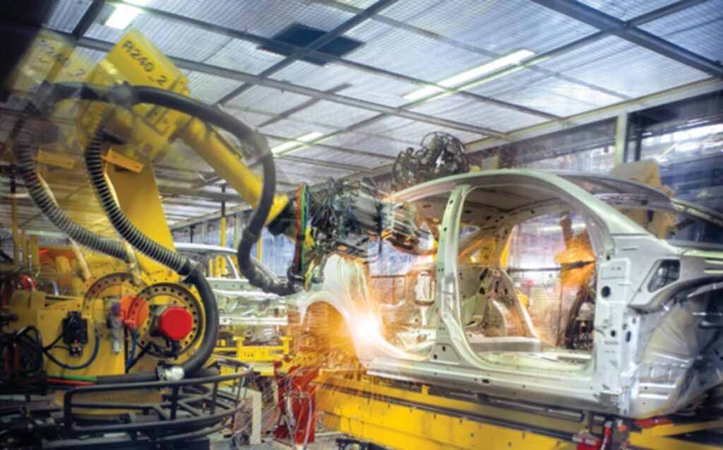 A Hytrel dress pack (corrugated tube) contains cabling and wires, keeping them protected and free from abrasion as an automotive welding robot moves along multiple axes.